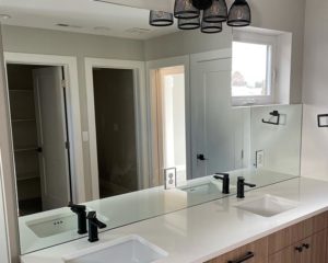 a new wall-to-wall mirror in bathroom