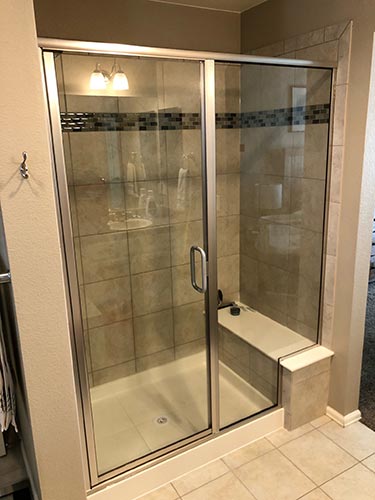 framed glass shower enclosure with seat