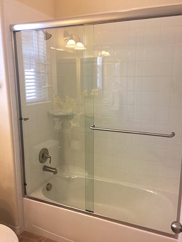 framed shower door on tub