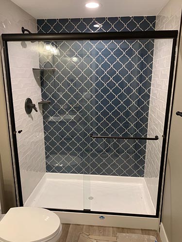 framed glass shower enclosure with sliding door