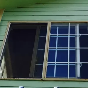 a rotten wood-framed window in need of replacing in Colorado