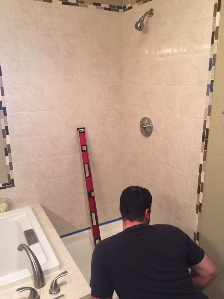 Matt is finding his center point on the sill and wall for this 3-panel shower enclosure in aurora colorado