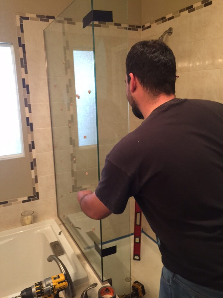 Making sure everything is level, u-channel is fully installed and anchored into the tile for this 3-panel shower enclosure in aurora colorado